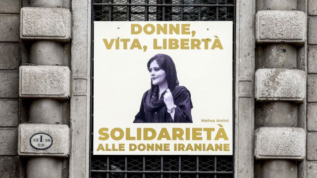 A portrait of Mahsa Amini with the words `Women, life, freedom. Solidarity with Iranian women` is displayed on the facade of Palazzo Marino, Milan`s city hall,